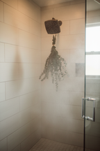 Eucalyptus shower bundle hanging in a steamy walk-in shower with glass door — Sensory for Calm