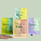 Four Floem boreal herbal tea packages in a flat lay on sage green background, showing all four varieties in the Discovery Set — Sensory for Calm