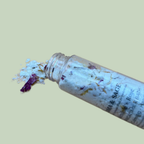 milk-bath-ritual-set-botanical-bottle-detail-sensory-for-calm
Alt text: Close-up of an open Soma & Sage milk bath bottle with white flakes, dried botanical petals spilling onto a pale sage background.