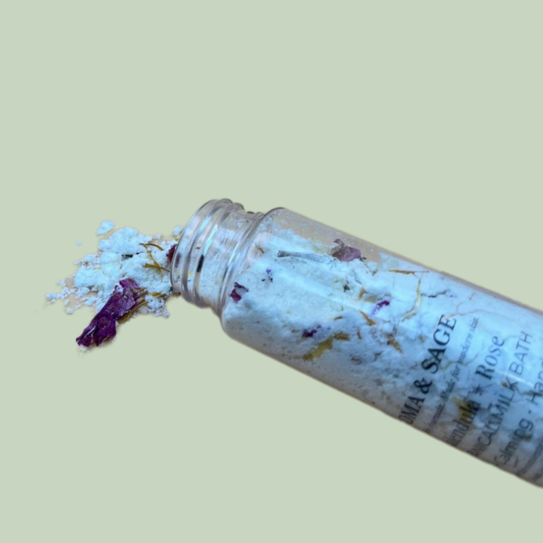 milk-bath-ritual-set-botanical-bottle-detail-sensory-for-calm
Alt text: Close-up of an open Soma & Sage milk bath bottle with white flakes, dried botanical petals spilling onto a pale sage background.